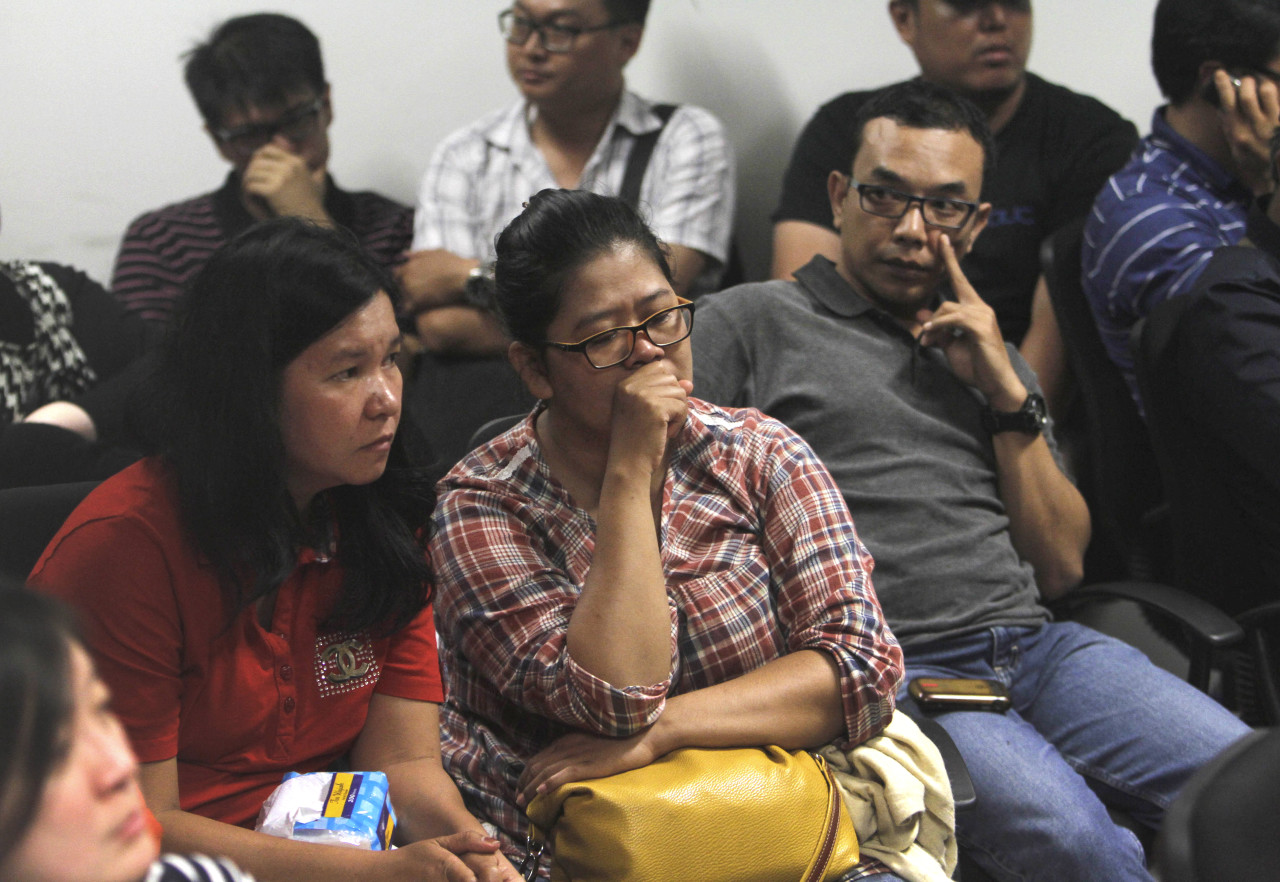 Relatives of the passengers of AirAsia flight QZ8015 wait for the latest news on the search of the missing jetliner at Juanda International Airport in Surabaya, East Java, Indonesia, Sunday (Trisnadi/AP)