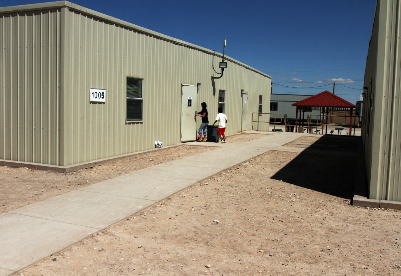 Children are seen entering a dormitory in the soon-to-close Artesia Family Residential Center, a federal detention facility for undocumented immigrants in Artesia, N.M, on Sept. 10. (Juan Carlos Llorca/AP)