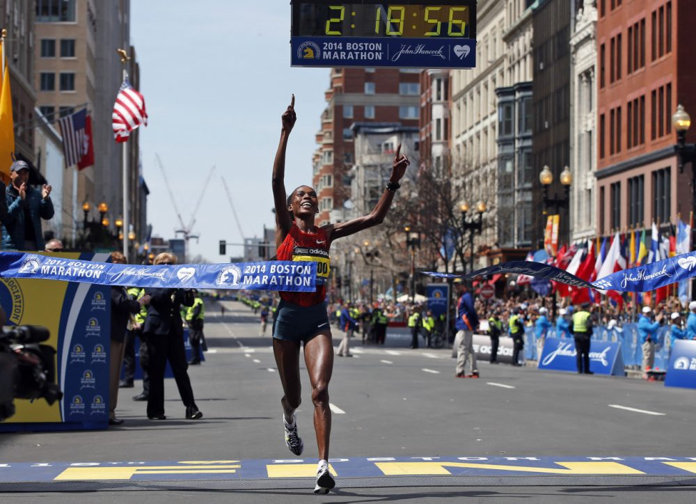 Rita Jeptoo, of Kenya, breaks the tape to win the women's division of the 118th Boston Marathon Monday, April 21, 2014 in Boston. (AP Photo/Elise Amendola)