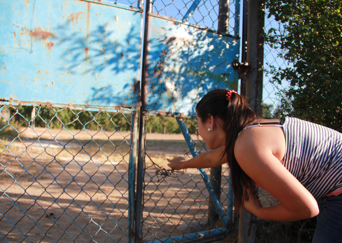 Dora's younger daughter shows the location in Aqua Caliente where Dora's son was killed. (Shannon Dooling/WBUR)