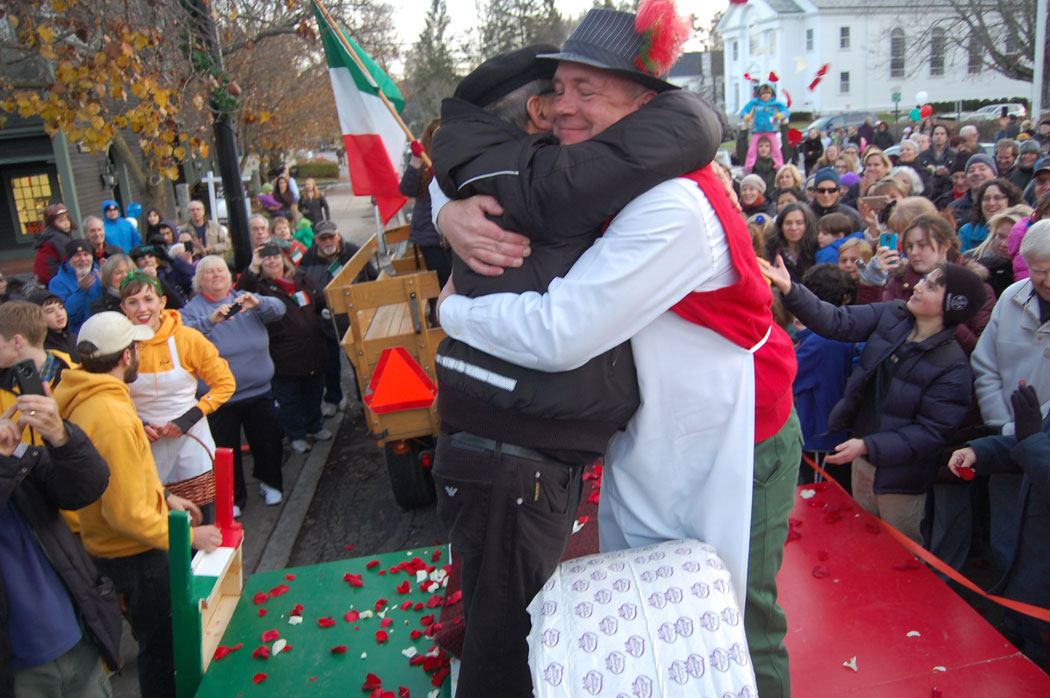 Peter Lovis hugs representative of Rifugio Crucolo over the 400-pound cheese. (Greg Cook)