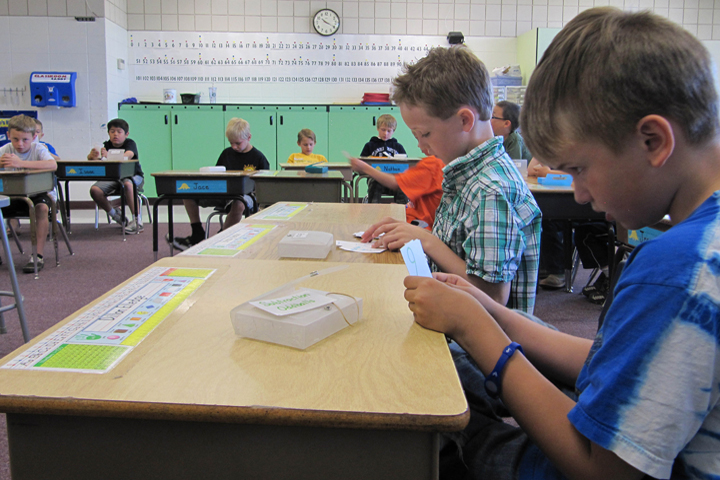 In this file photo taken May 9, 2012, Dillon Elledge, 8, right, and Brody Kemble, 7, second from right, work with flash cards in their all-boys classroom at Middleton Heights Elementary in Middleton, Idaho.  (AP)