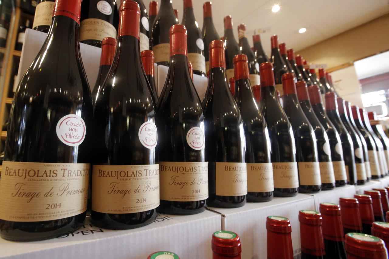 Bottles of Beaujolais Nouveau wine are displayed in a wine store at Issy Les Moulineaux, outskirts of Paris, Thursday Nov. 20, 2014. (AP)