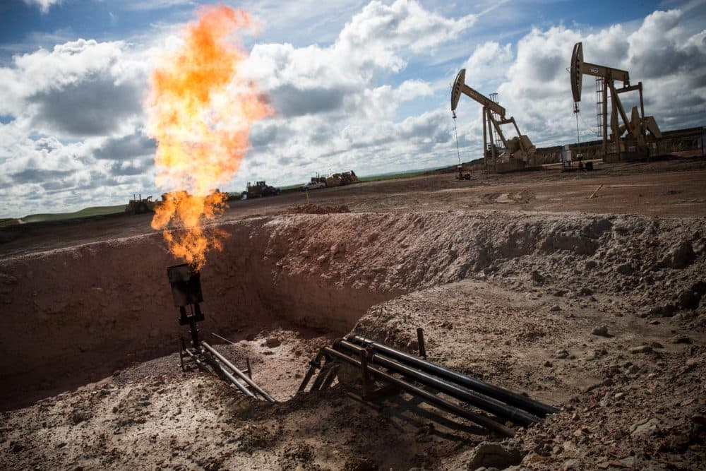 A gas flare is seen at an oil well site on July 26, 2013 outside Williston, North Dakota. Gas flares are created when excess flammable gases are released by pressure release valves during the drilling for oil and natural gas. (Andrew Burton/Getty Images)