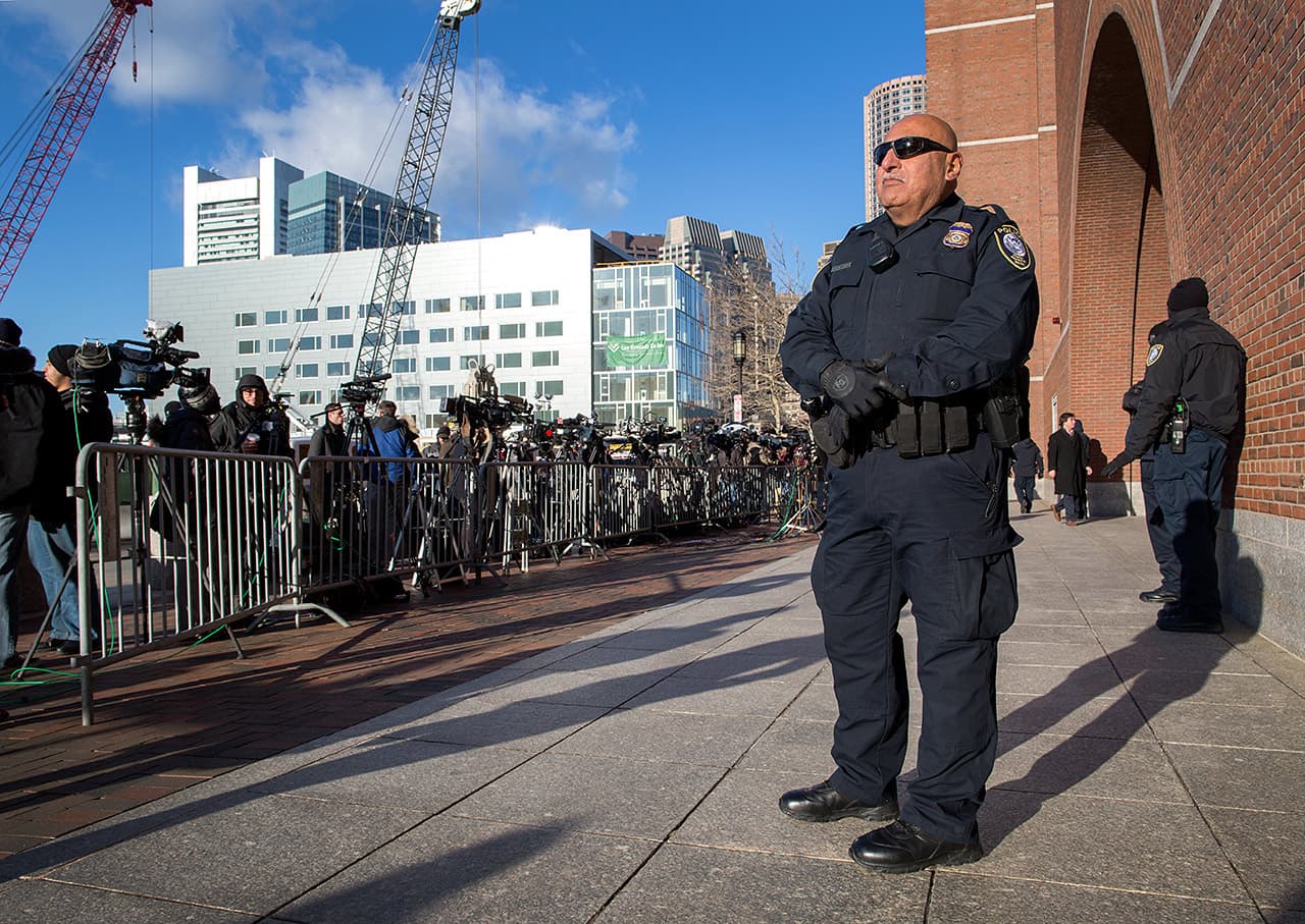A Department of Homeland Security officer stands outside the Moakley Courthouse in Boston, on the first day of the Tsarnaev trial. (Robin Lubbock/WBUR)