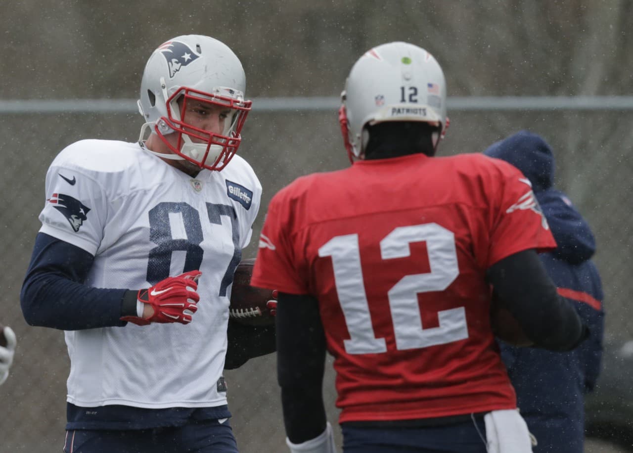 When the New England Patriots face the Baltimore Ravens in the AFC playoffs on Saturday, quarterback Tom Brady (r) will have Rob Gronkowski available. The tight end missed the last playoff game betwen the the teams. (Charles Krupa/AP)
