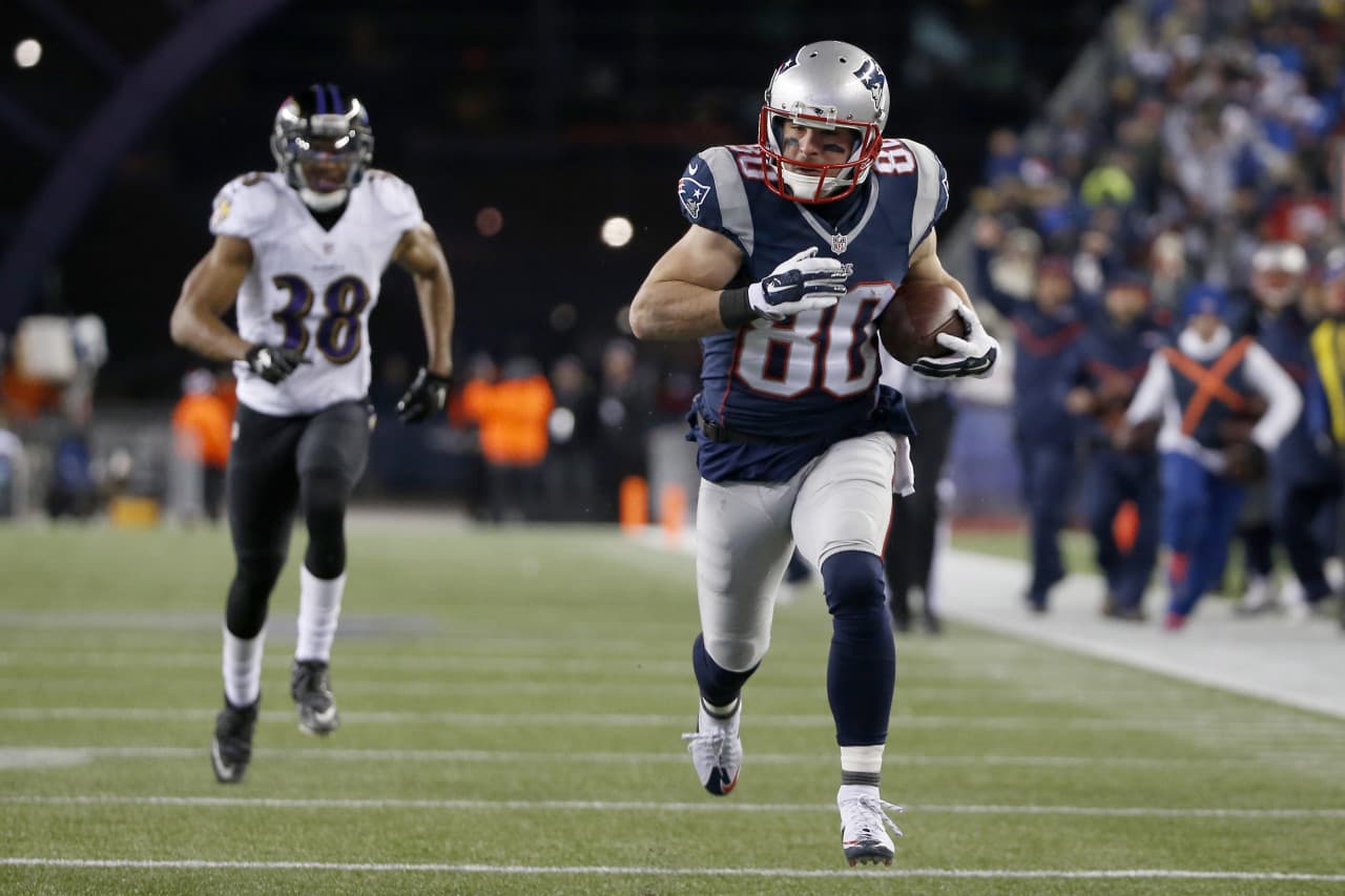 New England Patriots wide receiver Danny Amendola (80) runs with a touchdown pass from Julian Edelman, as he runs from Baltimore Ravens defensive back Rashaan Melvin (38) in the second half of an NFL divisional playoff football game Saturday. (Elise Amendola/AP)