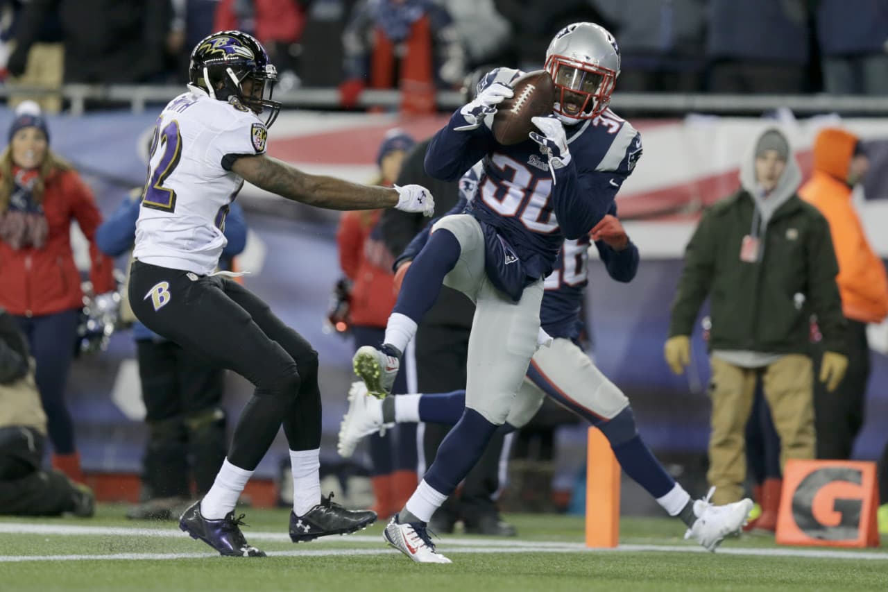 New England Patriots strong safety Duron Harmon (30) intercepts a pass by Baltimore Ravens quarterback Joe Flacco in front of Baltimore Ravens wide receiver Torrey Smith (82) in the second half. (Charles Krupa/AP)