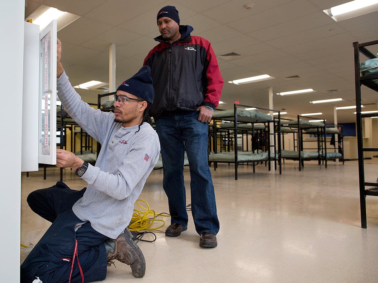 Workers are pushing to complete the first phase of renovations to turn an old Boston transportation building at 112 Southampton St. into a new homeless shelter. On Tuesday, the facility is expected to open 100 beds. (Robin Lubbock/WBUR)