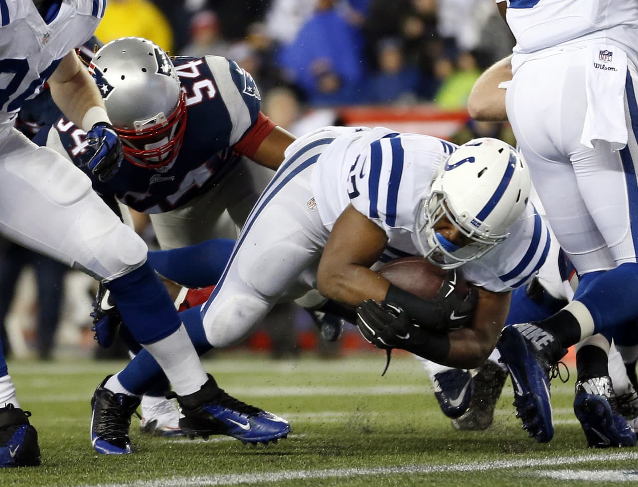 Indianapolis Colts running back Zurlon Tipton (37) scores on a one-yard touchdown run past the Patriots outside linebacker Dont'a Hightower (54) during the first half of the AFC Championship. (Julio Cortez/AP)