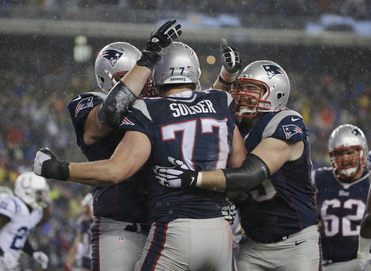 New England Patriots tackle Nate Solder (77) celebrates following a touchdown reception during the second half of the AFC Championship as the rain got heavier. (Matt Slocum/AP)