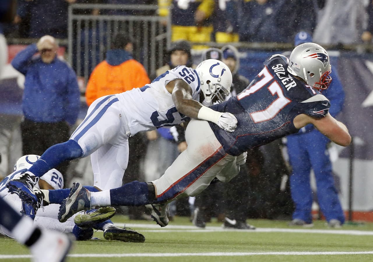 New England Patriots tackle Nate Solder (77) scores on a 16-yard touchdown catch from quarterback Tom Brady against Indianapolis Colts inside linebacker D'Qwell Jackson (52) during the second half of the AFC Championship game in Foxborough, Mass. (Elise Amendola/AP)