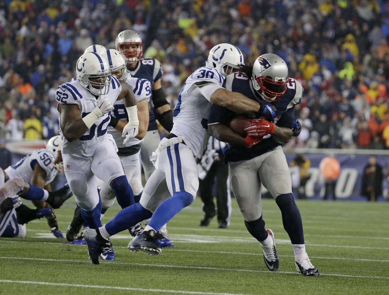 New England Patriots running back LeGarrette Blount (29) is tackled by Indianapolis Colts free safety LaRon Landry (30) during the second half of the AFC Championship. (Matt Slocum/AP)