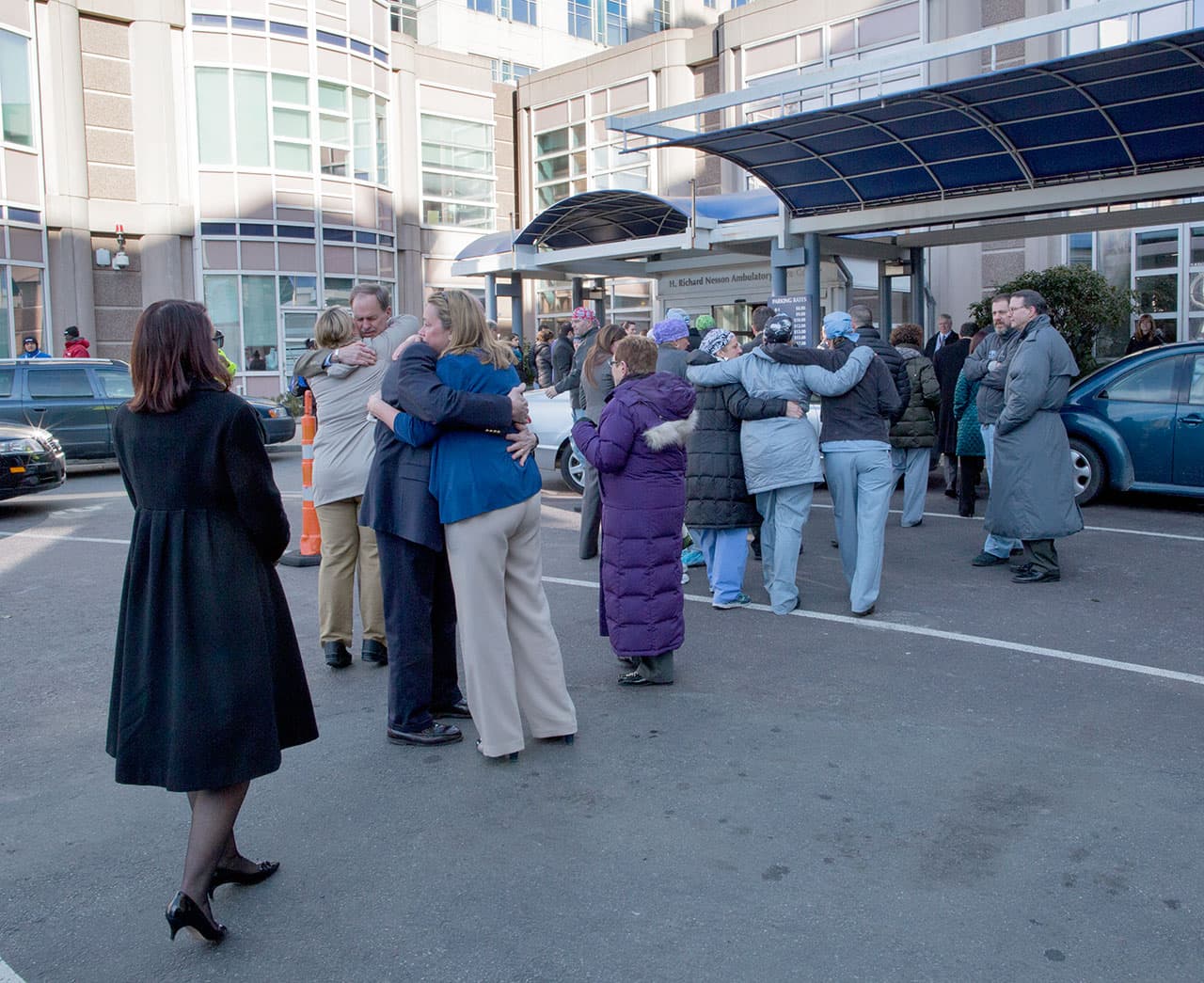 Brigham and Women's Hospital staff embrace after a ceremony remembering Dr. Michael Davidson on Wednesday. (Robin Lubbock/WBUR)