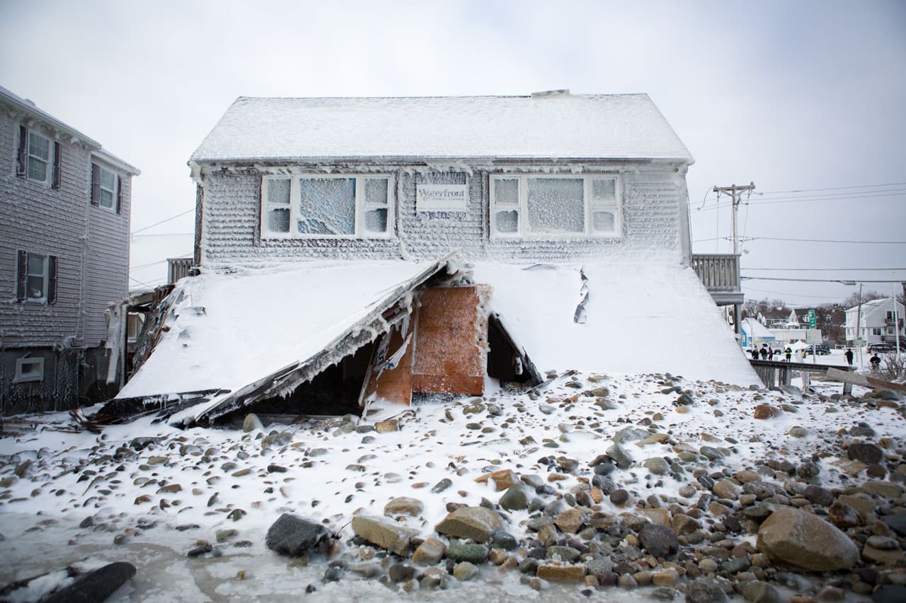 One of the many homes damaged on Brant Rock in Marshfield due to the breach in the seawall. (Jesse Costa/WBUR)