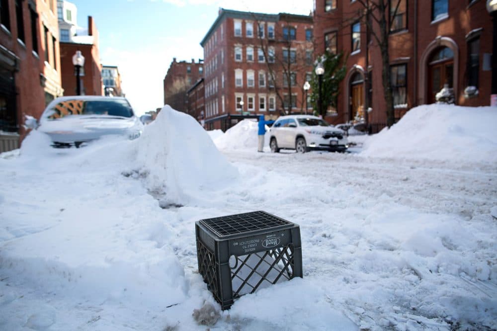 A milk crate was used to save a space on West Concord Street in the South End at the end of January.  (Robin Lubbock/WBUR)