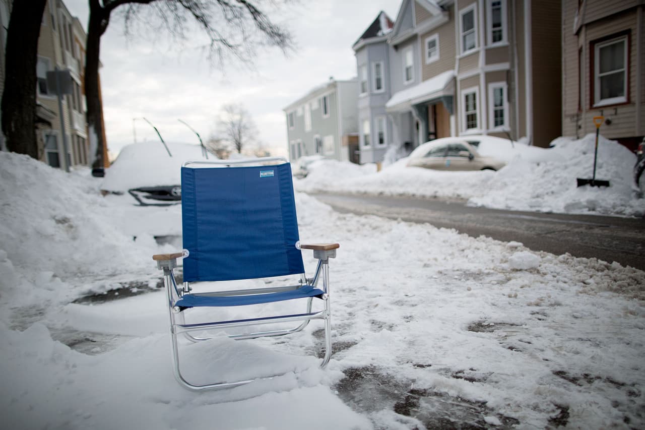 Beach chairs don’t only have to come out in the summer. This blue beach chair marks a parking space on I St. in South Boston. (Robin Lubbock/WBUR)
