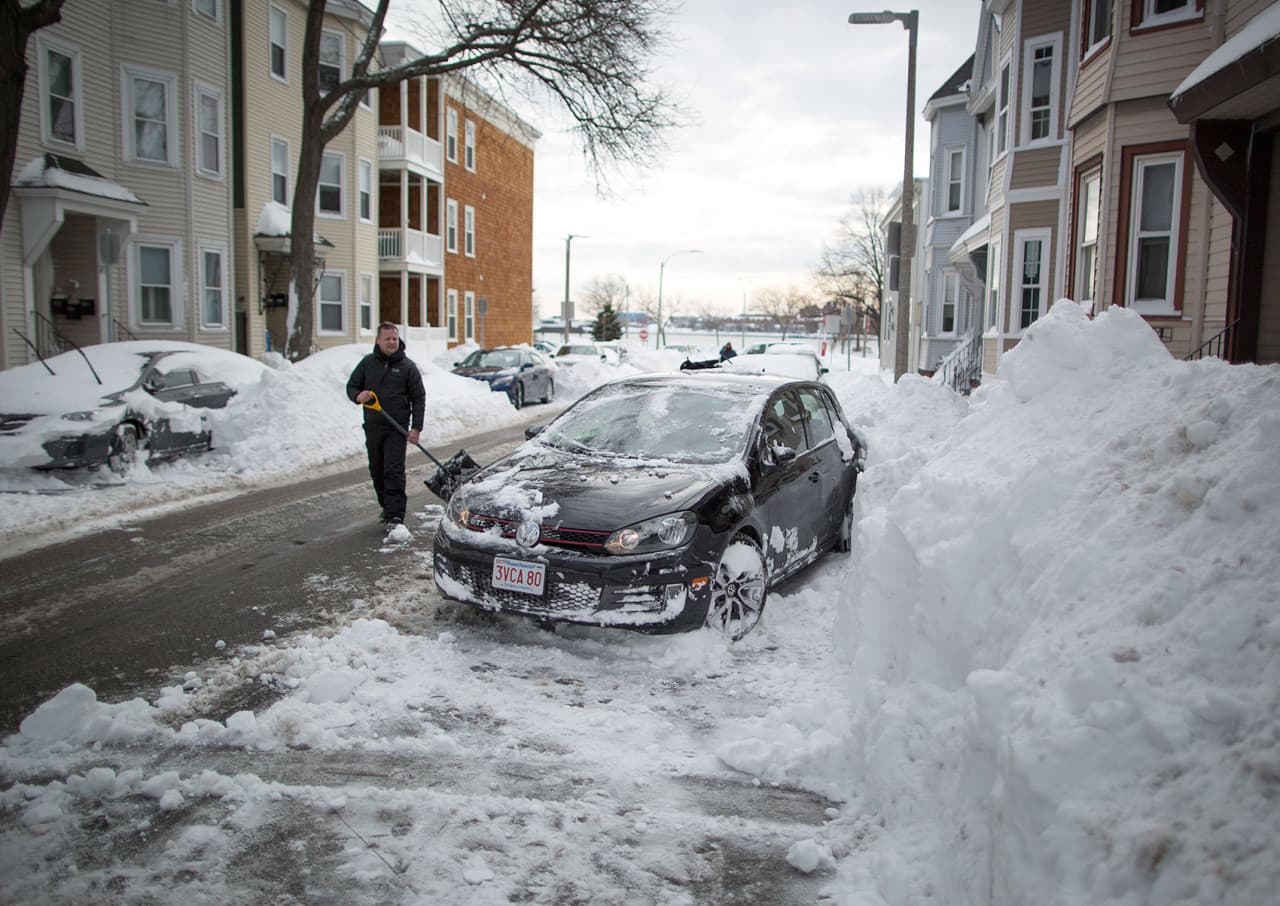 Eddie McLaughlin surveys the space he’s cleared for his car on I St. in South Boston. He says space saving in South Boston is “a tradition.” (Robin Lubbock/WBUR)