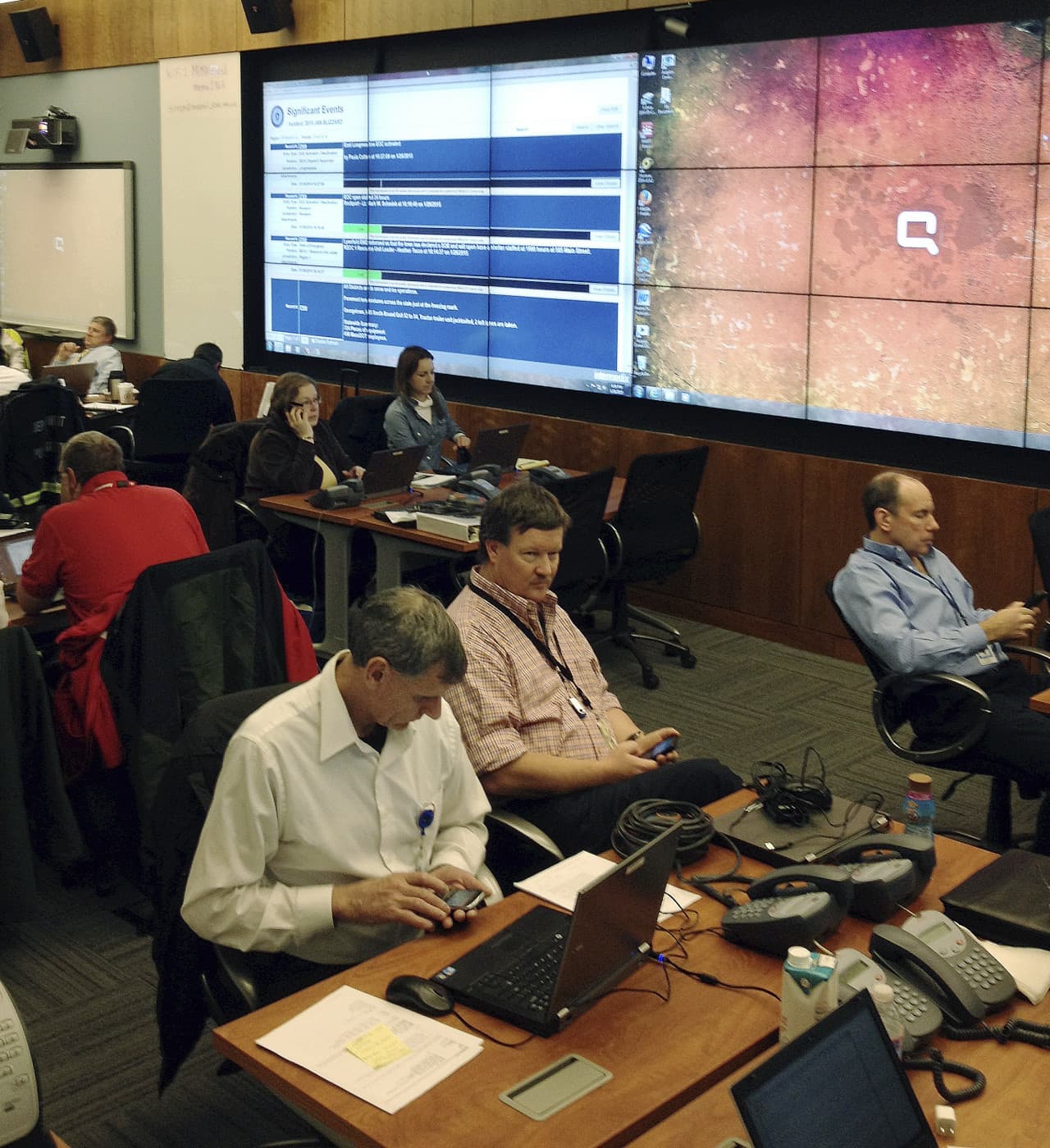 Workers man the operations center Monday at the Massachusetts Emergency Management Agency in Framingham, Mass., where Baker met with officials coordinating the state's response to the storm. (Bob Salsberg/AP)