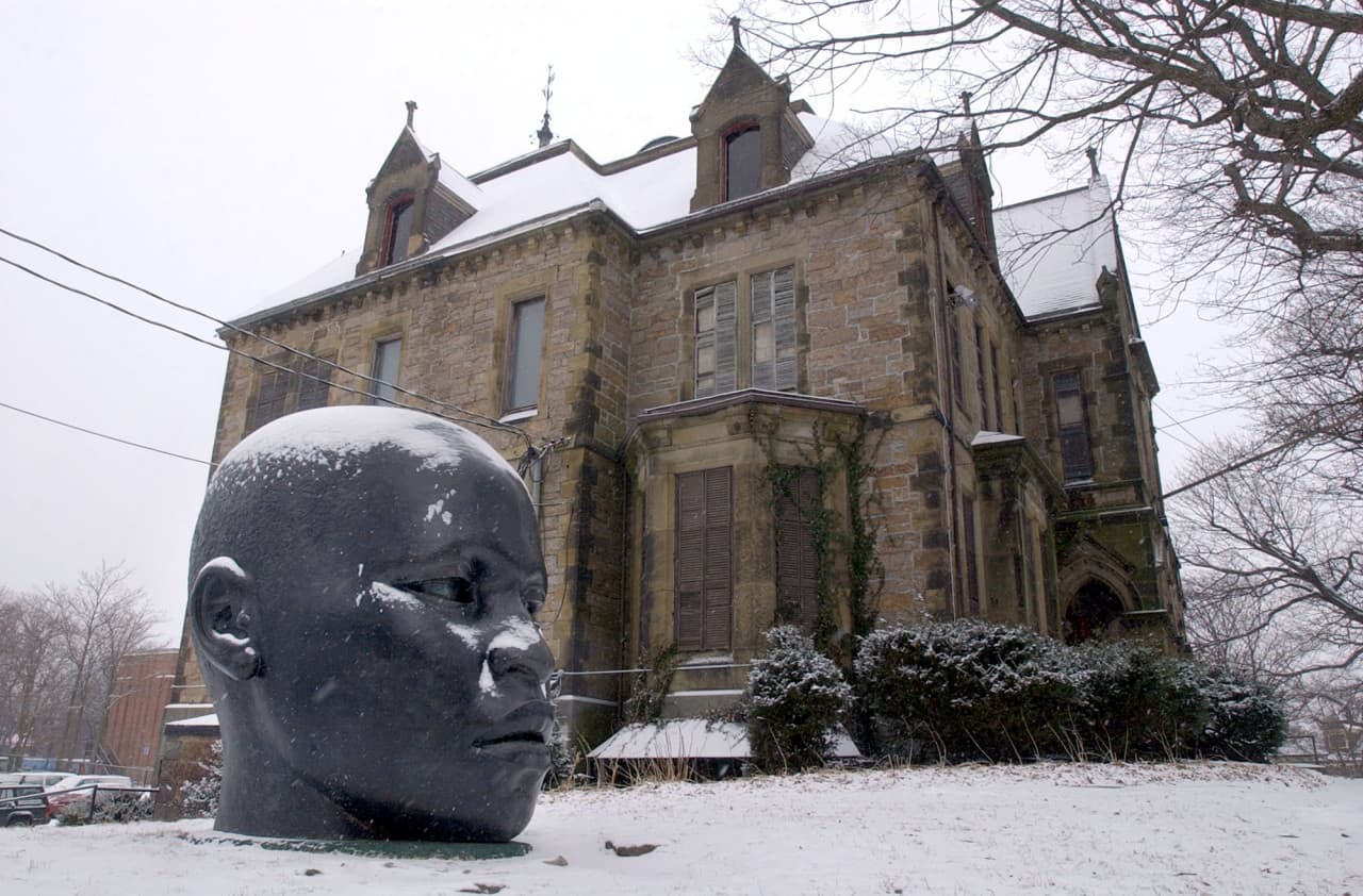 The sculpture "Eternal Presence," by John Wilson, is dusted with snow in front of the Museum of the National Center of Afro-American Artists in the Roxbury neighborhood in Boston Jan. 28, 2004. (Chitose Suzuki/AP)