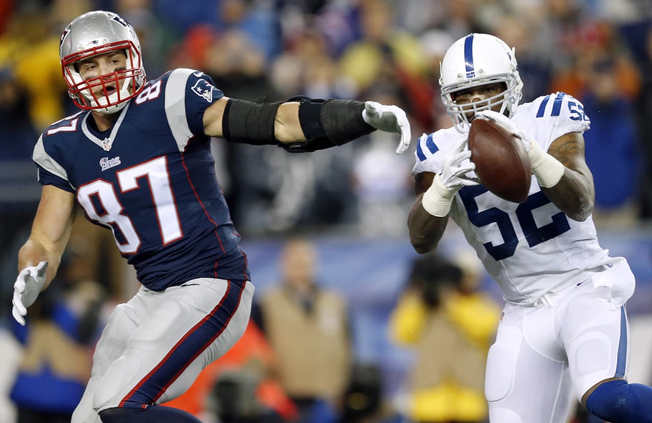 In this Sunday, Jan. 18, 2015 photo, Colts inside linebacker D'Qwell Jackson intercepts a pass intended for Patriots tight end Rob Gronkowski. The NFL is investigating whether the Pats deflated footballs that were used in their AFC championship game victory over Colts. (Julio Cortez/AP)