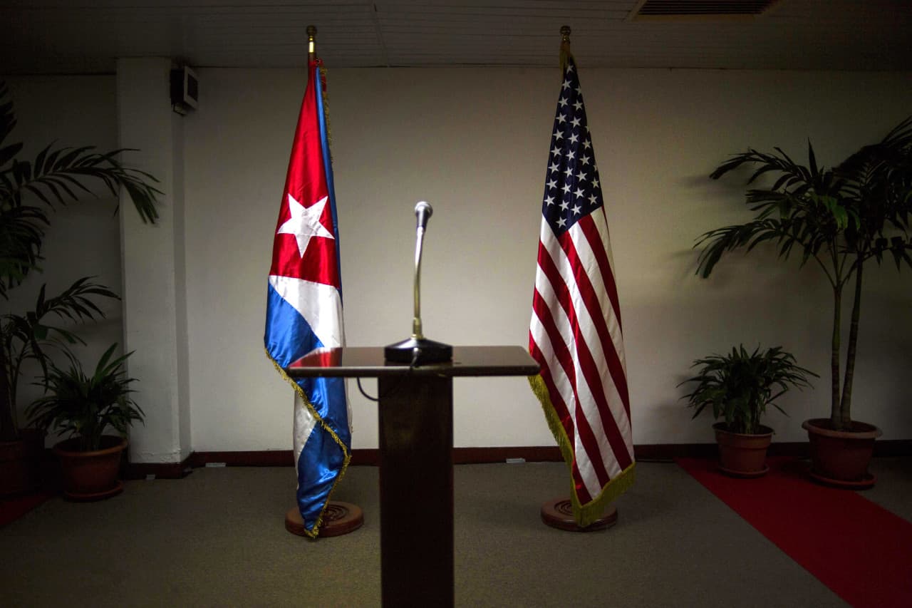 A Cuban flag and an American flag stand in the press room during the second day of talks between U.S. and Cuban officials, in Havana, Cuba, Thursday, Jan. 22, 2015. (AP)