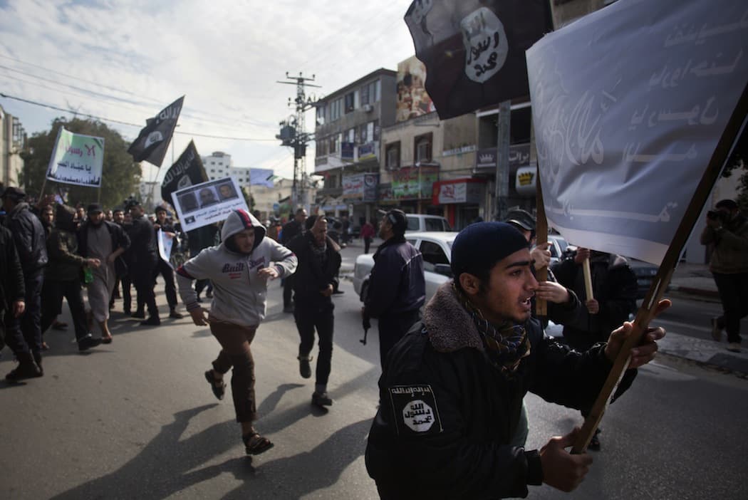 Palestinian Salafists, members of an ultraconservative sect of Islam, break past a police checkpoint during a protest against caricatures of the Prophet Muhammad published in the satirical French weekly magazine Charlie Hebdo, outside the French Cultural Center in Gaza City, Monday, Jan. 19, 2015. (Khalil Hamra/AP)