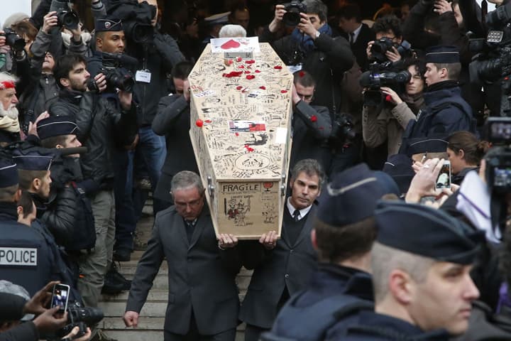 Pallbearers carry the casket of Charlie Hebdo cartoonist Bernard Verlhac, known as Tignous, decorated by friends and colleagues of the satirical newspaper Charlie Hebdo, at the city hall of Montreuil, outside east of Paris, Thursday, Jan. 15, 2015. (AP)