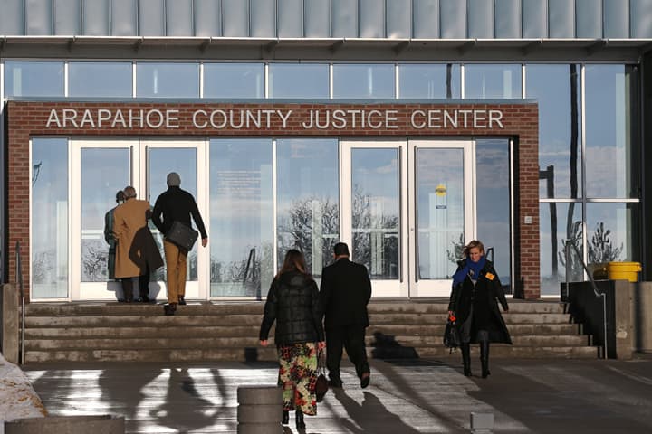 People enter the Arapahoe County Justice Center in Centennial, Colo., Tuesday, Jan. 20, 2015. The jury selection process in the trial of Aurora theater shooting suspect James Holmes began Tuesday, and is expected to take several weeks to a few months. Holmes is charged with killing 12 people and wounding more than 50 in an Aurora movie theater in 2012 (AP)