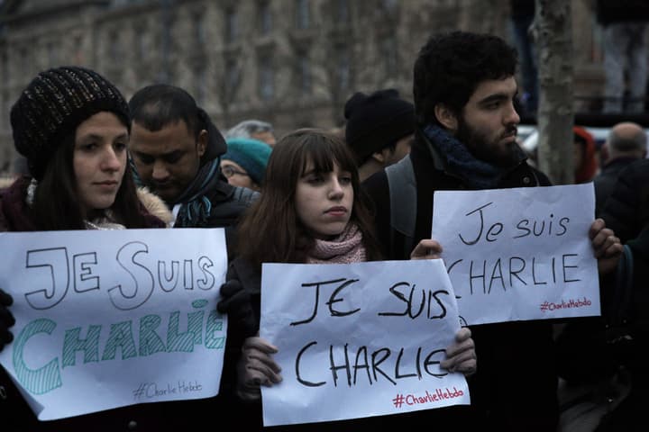 Demonstrators hold papers reading "I am Charlie", during a demonstration in Paris, Wednesday, Jan. 7, 2015. Three masked gunmen shouting "Allahu akbar!" stormed the Paris offices of a satirical newspaper, Charlie Hebdo, Wednesday, killing 12 people, including its editor, before escaping in a car. It was France's deadliest postwar terrorist attack. (AP)
