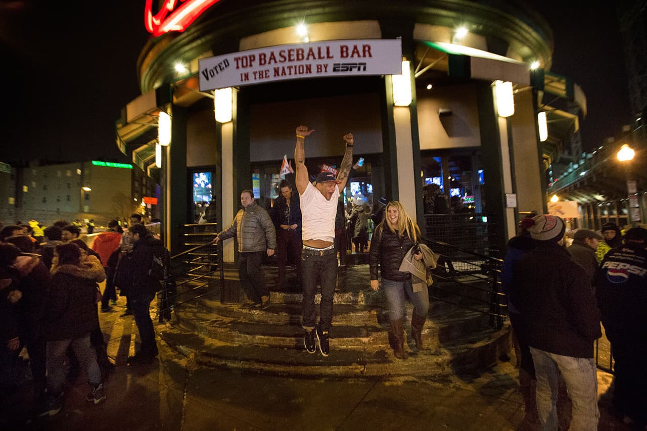 Patriots fans emerge from the Cask ‘n Flagon after the Patriots win the Super Bowl. (Jesse Costa/WBUR)