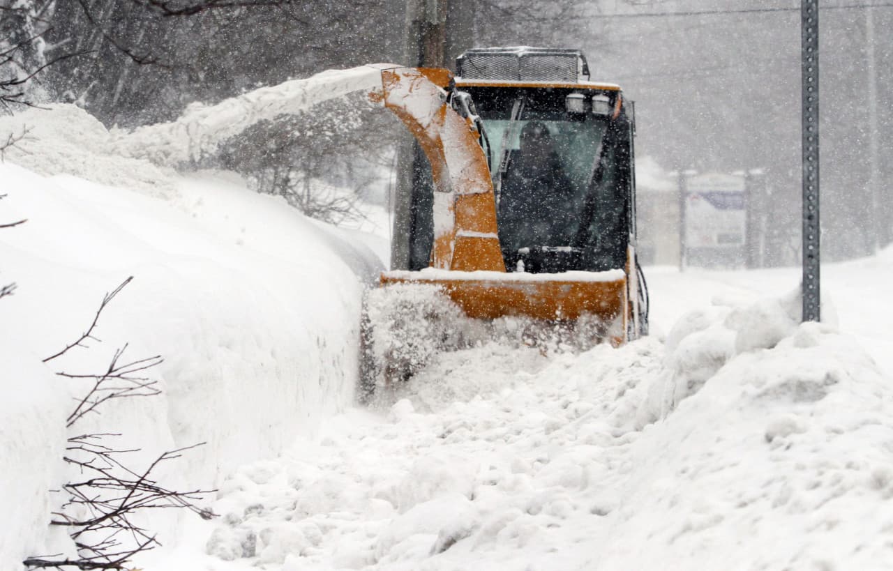 City worker Jeff D'Amico clears snow from a sidewalk Monday in Marlborough. (Bill Sikes/AP)