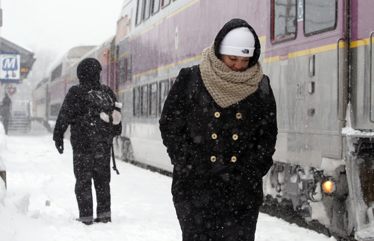 Passengers wait at the commuter rail train station Monday in Framingham, Mass. (Bill Sikes/AP)
