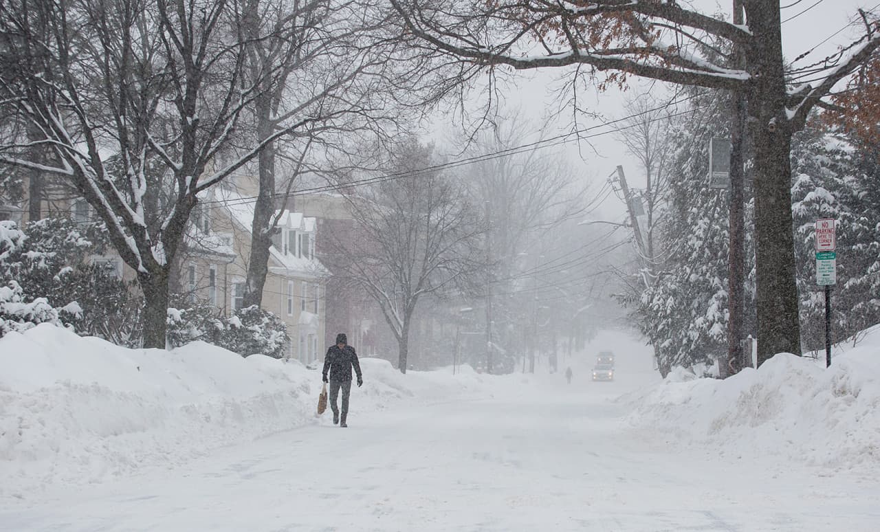 A man walks through the storm along Longwood Avenue in Brookline Monday. (Robin Lubbock/WBUR)