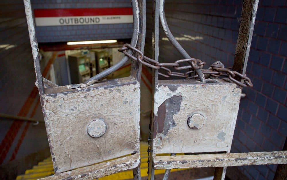 The entrance to the Central Square Red Line station was chained closed Tuesday as the MBTA suspended all rail service following Monday's storm. (Robin Lubbock/WBUR)