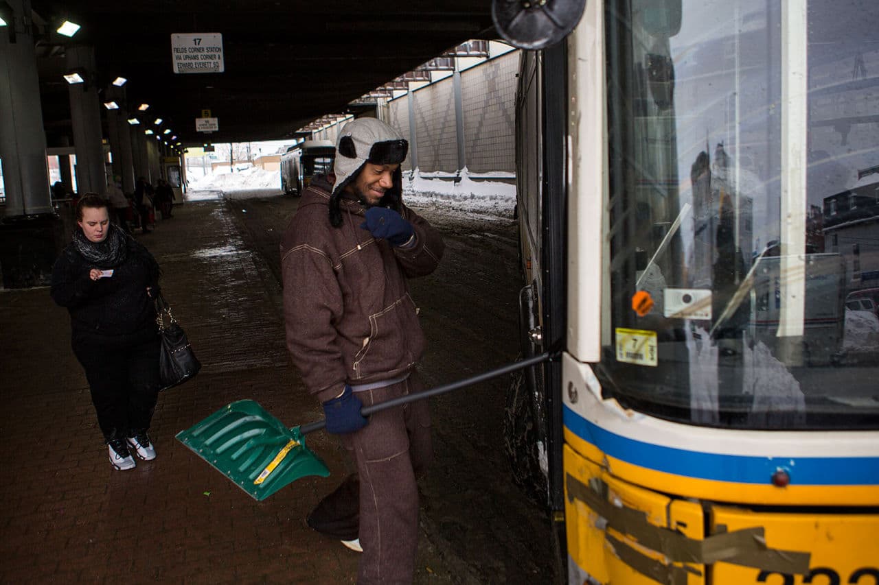 On his way home, Miguel Natal gets on a #16 bus with his shovel after performing a couple of shoveling jobs in Cambridge. (Jesse Costa/WBUR)