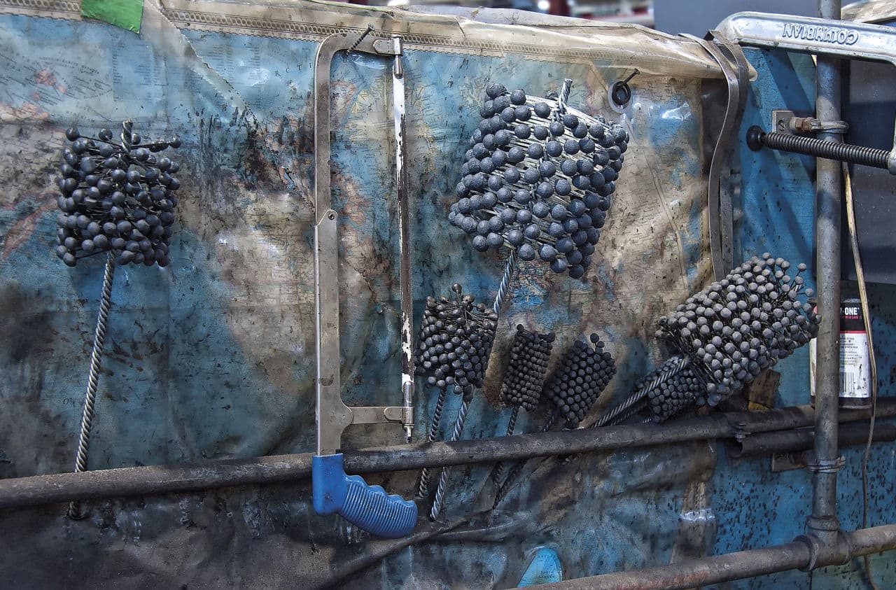 A subway train uses compressed air to close and open doors or trigger brakes to stop the train. The air tubes need to be descaled after many years of use. This is the purpose of these bluish-gray, cylindrical shaped tools. (Courtesy Joseph R. Votano)