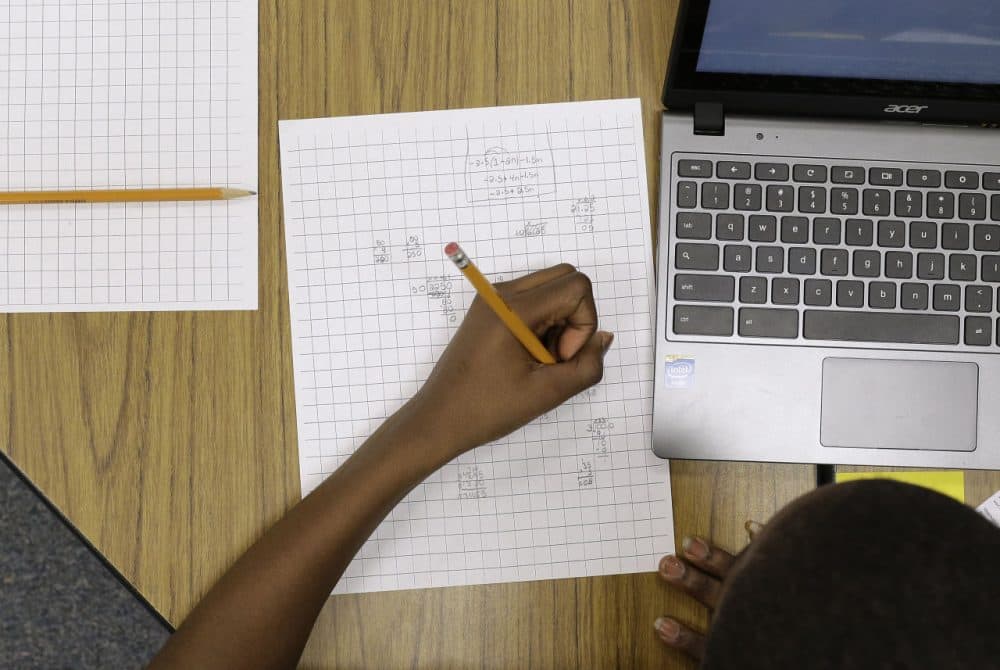 In this Feb. 12, 2015 photo, Yamarko Brown, age 12, works on math problems as part of a trial run of a new state assessment test at Annapolis Middle School in Annapolis, Md. (Patrick Semansky/AP)
