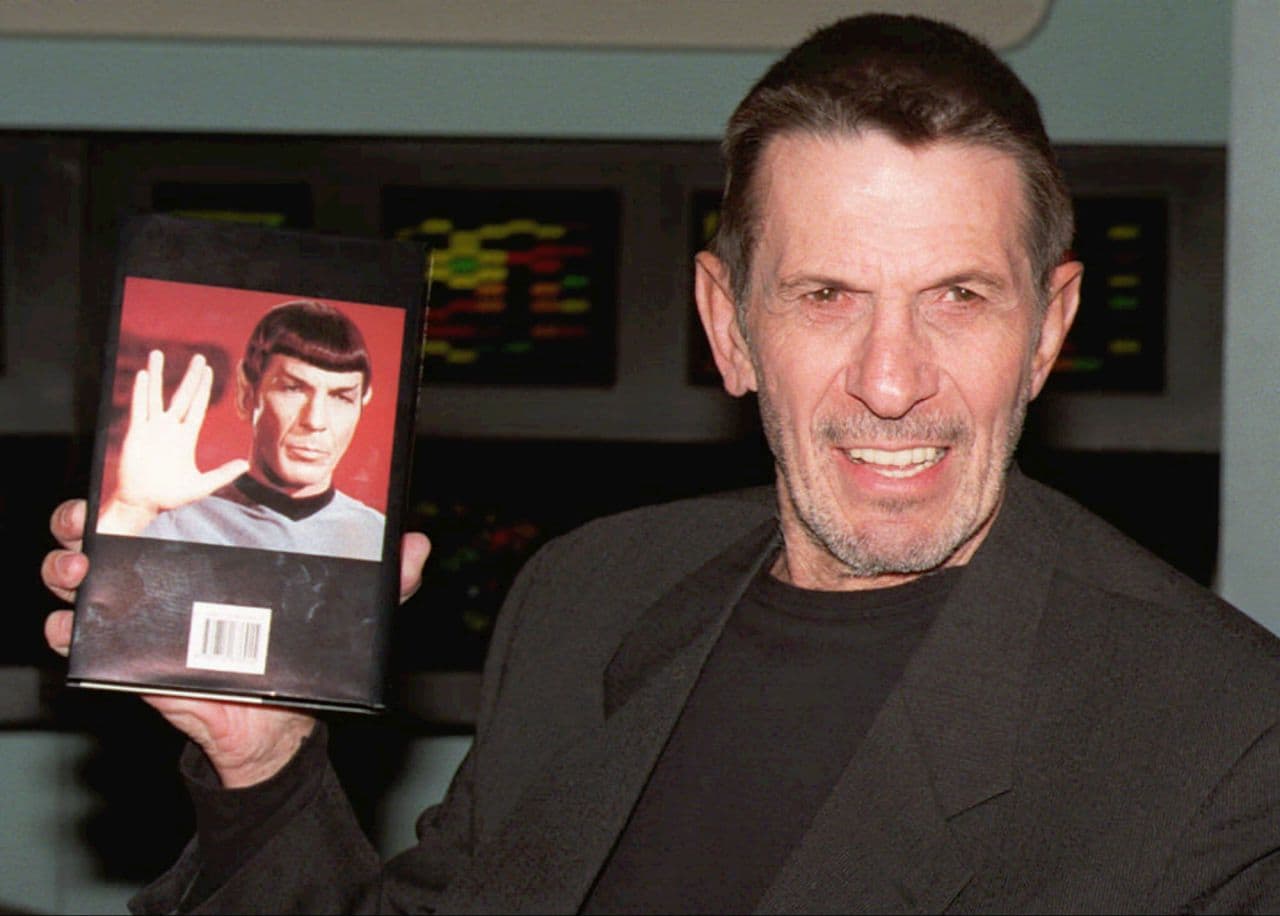 Leonard Nimoy holds a copy of his autobiography which is titled "I am Spock" at the Science Museum in London in 1995. (Michael Stephens/PA/AP)