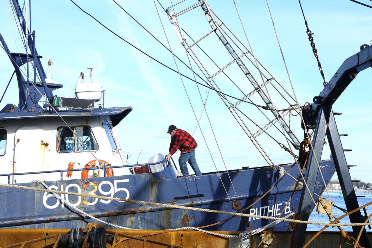 Willis Blount stands on his boat, "Ruthie B." He's spent more than a half century fishing, and in recent years, he's pressed on through the scary financial realities that have befallen his industry. (Simón Rios/WBUR)