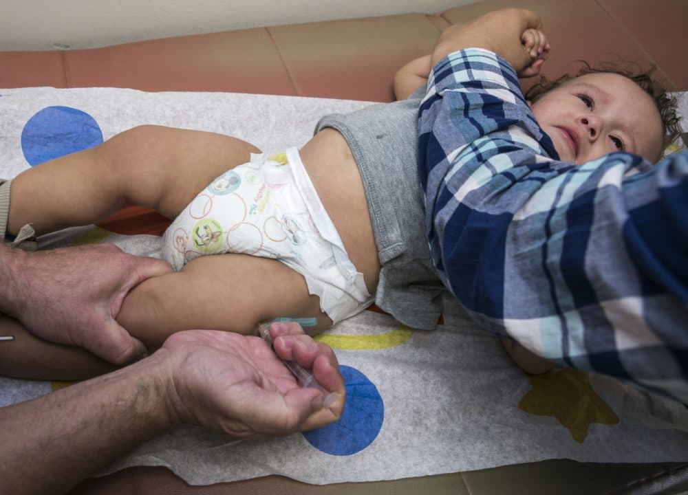 In this Jan. 29 photo, pediatrician Charles Goodman vaccinates 1-year-old Cameron Fierro with the measles-mumps-rubella vaccine, or MMR vaccine, at his practice in Northridge, Calif. The measles outbreak that originated at Disneyland in December has prompted politicians to weigh in and parents to voice their vaccinations views on Internet message boards. (Damian Dovarganes/AP)