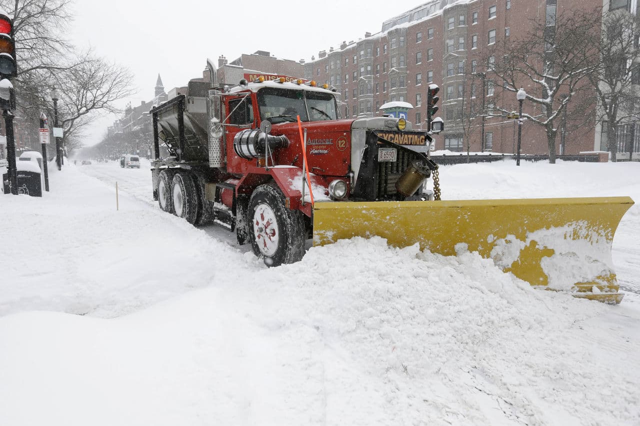 A plow clears snow from a city street Monday, Feb. 9, 2015, in Boston. A long duration winter storm that began Saturday night remains in effect for a large swath of southern New England until the early morning hours Tuesday. (AP)