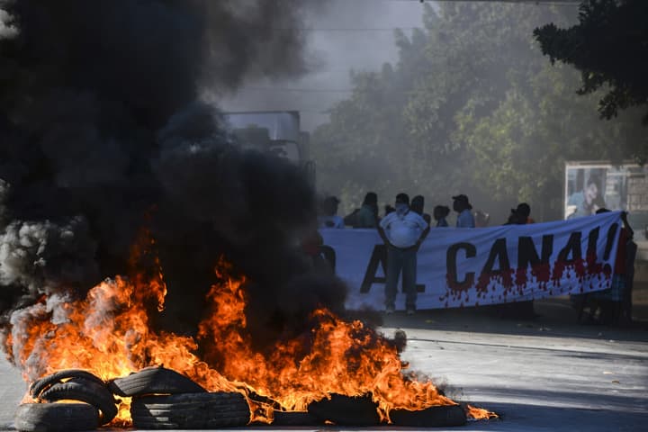 Residents burn tires at a blockade on the Pan-American highway during the groundbreaking day of the $50 billion transoceanic waterway construction project predicted to rival the Panama Canal, in Managua, Nicaragua, Monday, Dec. 22. 2014. (AP)