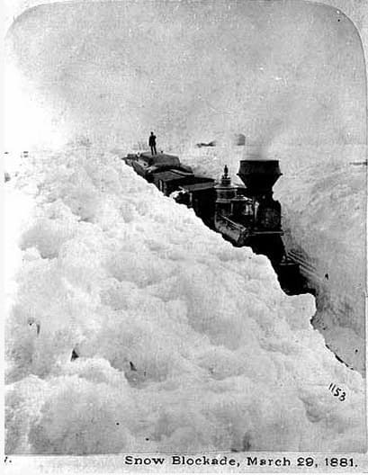 A train stuck in snow in 1881, the ferocious winter Laura Ingalls Wilder wrote about. Note the man standing on top for scale. (Minnesota Historical Society on Wikimedia Commons)
