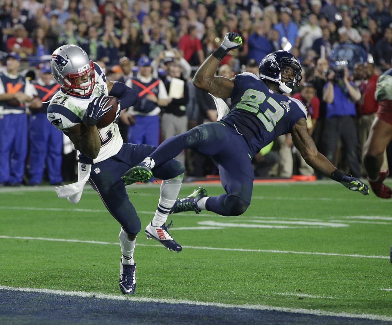 New England Patriots strong safety Malcolm Butler (21) intercepts a pass intended for Seattle Seahawks wide receiver Ricardo Lockette (83) during the second half of NFL Super Bowl XLIX. (Kathy Willens/AP)