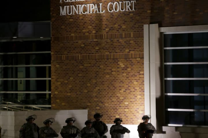 Guardsmen stand in front the Ferguson Police Department Municipal Court bulding, Tuesday, Nov. 25, 2014, in Ferguson, Mo. (AP)
