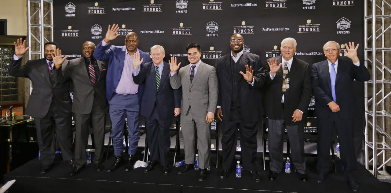Members of the NFL Pro Football Hall of Fame class of 2015 are introduced Saturday in Tempe, Ariz. From left are running back Jerome Bettis; wide receiver Tim Brown; defensive end and linebacker Charles Haley; Bill Polian; Tyler Seau, son of the late linebacker Junior Seau, on behalf of his father; guard Will Shields; center Mick Tingelhoff; and Ron Wolf. (Mark Humphrey/AP)