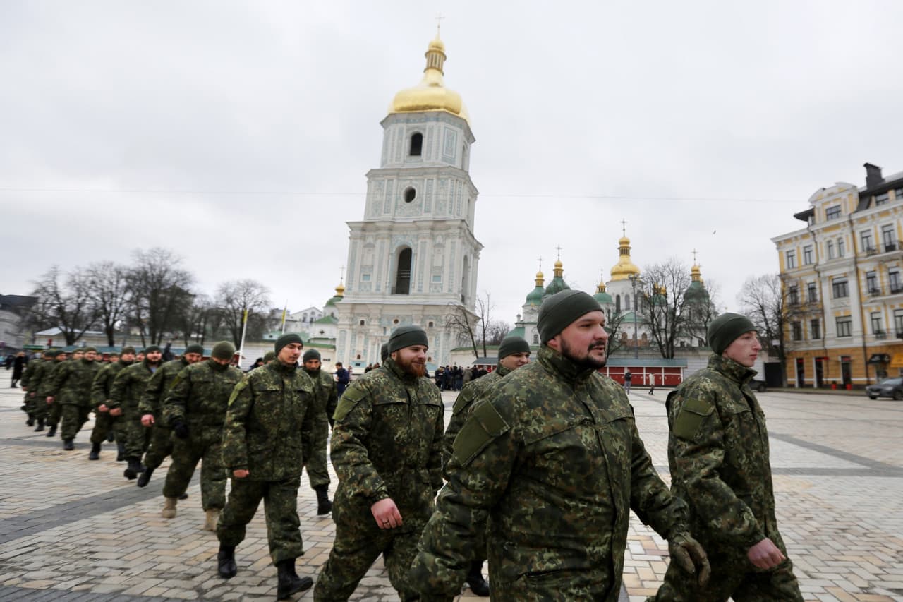 Volunteers of battalion "St. Maria" line up during a ceremony before to start military training in Internal Ministry unit at Sophia Square near the St. Sophia Cathedral in the Ukrainian capital in Kiev, Ukraine,Tuesday, Feb. 3, 2015. (AP)