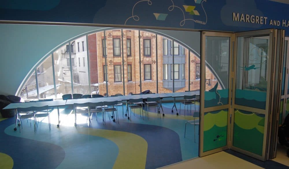The Children’s Library “has a retractable glass wall that has a Curious George theme,” Colford says. “There’s a screen and projector and curtain for theatrical performances. There is small bleacher seating for kids. There’s a sink and wet room for crafts.” (Greg Cook)