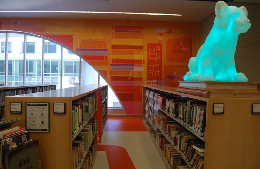 It’s supposed to be the Boston skyline, but created with books. They’re all by Boston authors or have Boston subject matter,” Colford says of these wall graphics in the Children’s Library that were created by Arrowstreet. The Boston design and architecture firm is developing the “wayfinding” signs for the entire building. (Greg Cook)